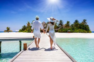 Couple holding hands on honeymoon in the Maldives 