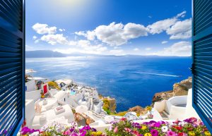 View of blue ocean and white houses in Greece - Leisure Travel Enterprises