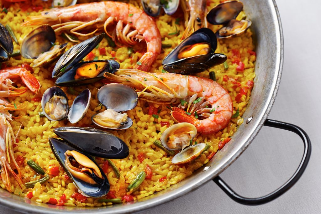 Typical spanish seafood paella in traditional pan - Leisure Travel Enterprises