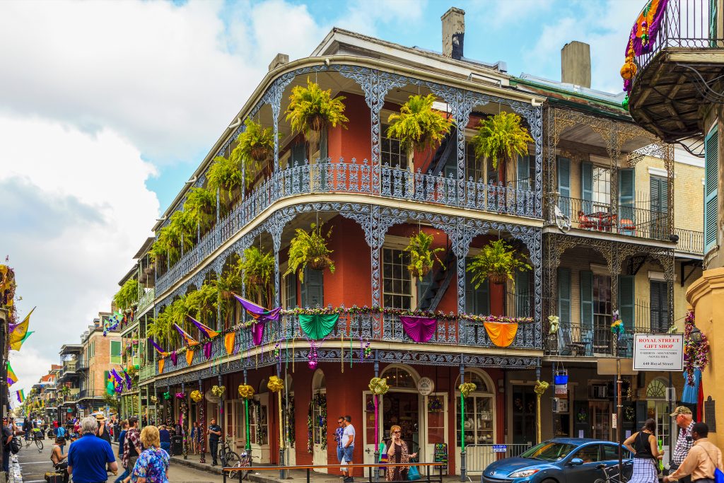 French Quarter's streets of New Orleans. People are celebrating and partying - Leisure Travel Enterprises