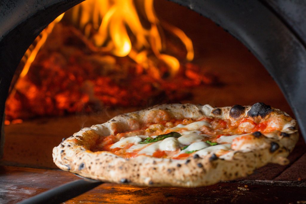 baked tasty margerita pizza near oven, Italy - Leisure Travel Enterprises 