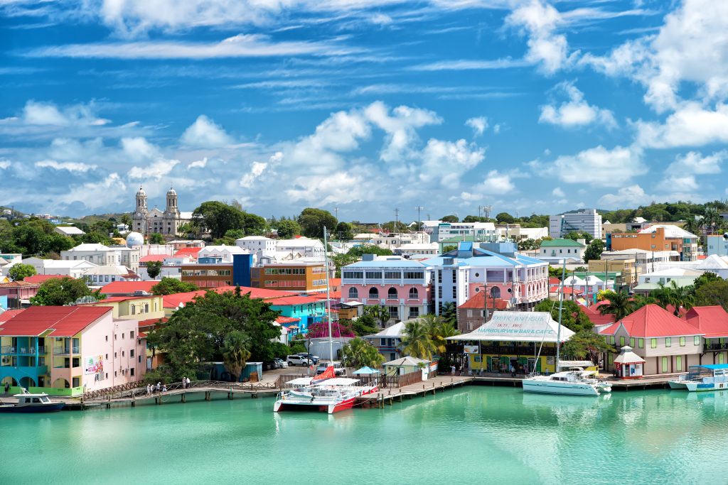 houses at harbor with yacht, boat, ship transportation in bay of St. John, Antigua - Leisure Travel Enterprises 