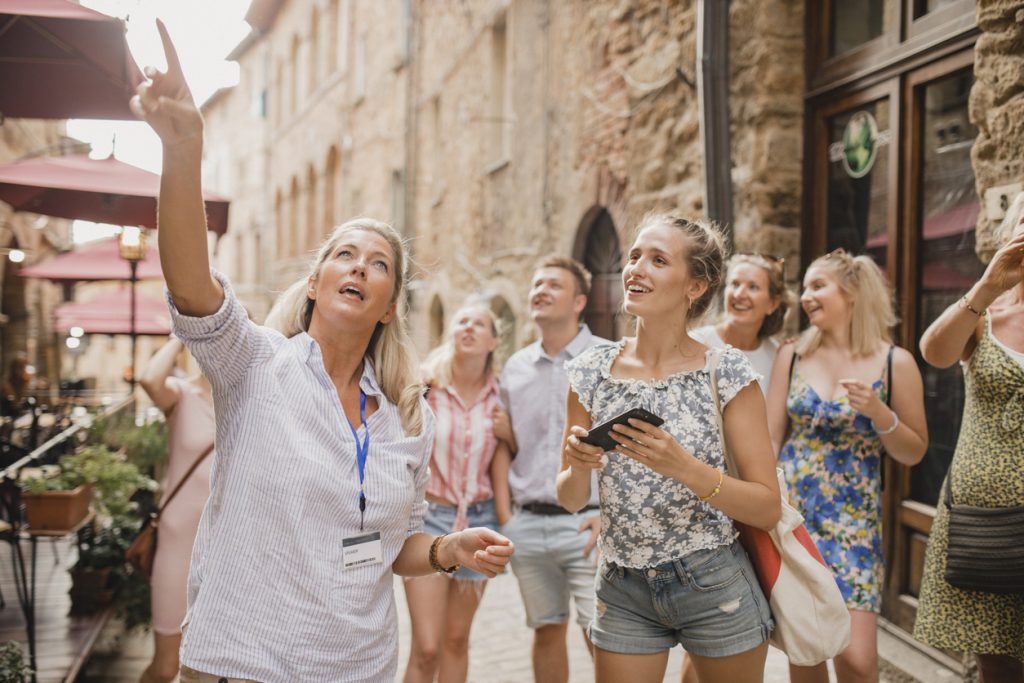  Group of people in a street in Volterra travelling - Leisure Travel 